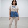 file_1524.jpg Chic Denim-Patch Graphic Tee and Flare Pants Set
